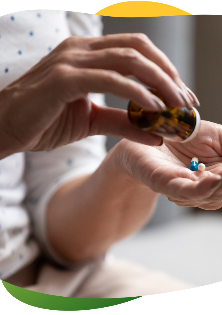 Woman’s hand pouring the medicine out of the bottle on her left palm