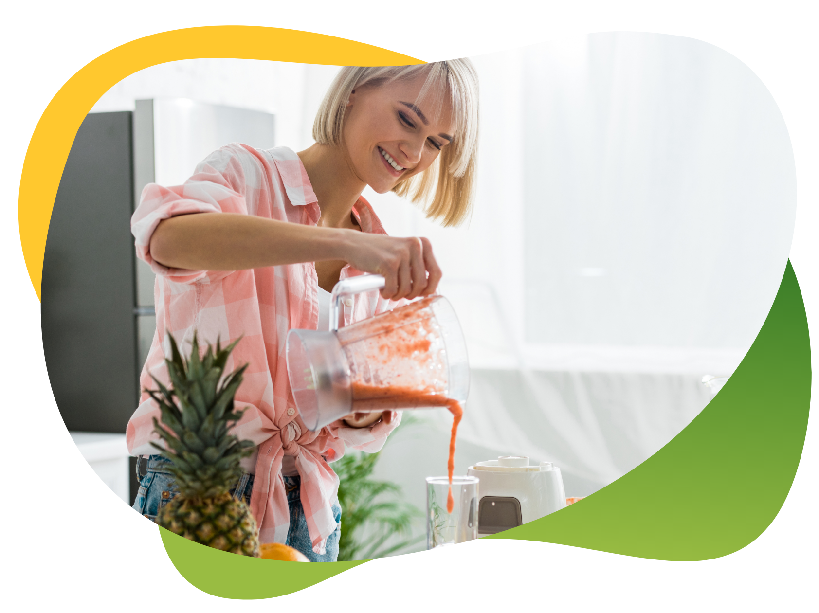 A blonde woman with a bob prepares her smoothie with pineapple and various fruits